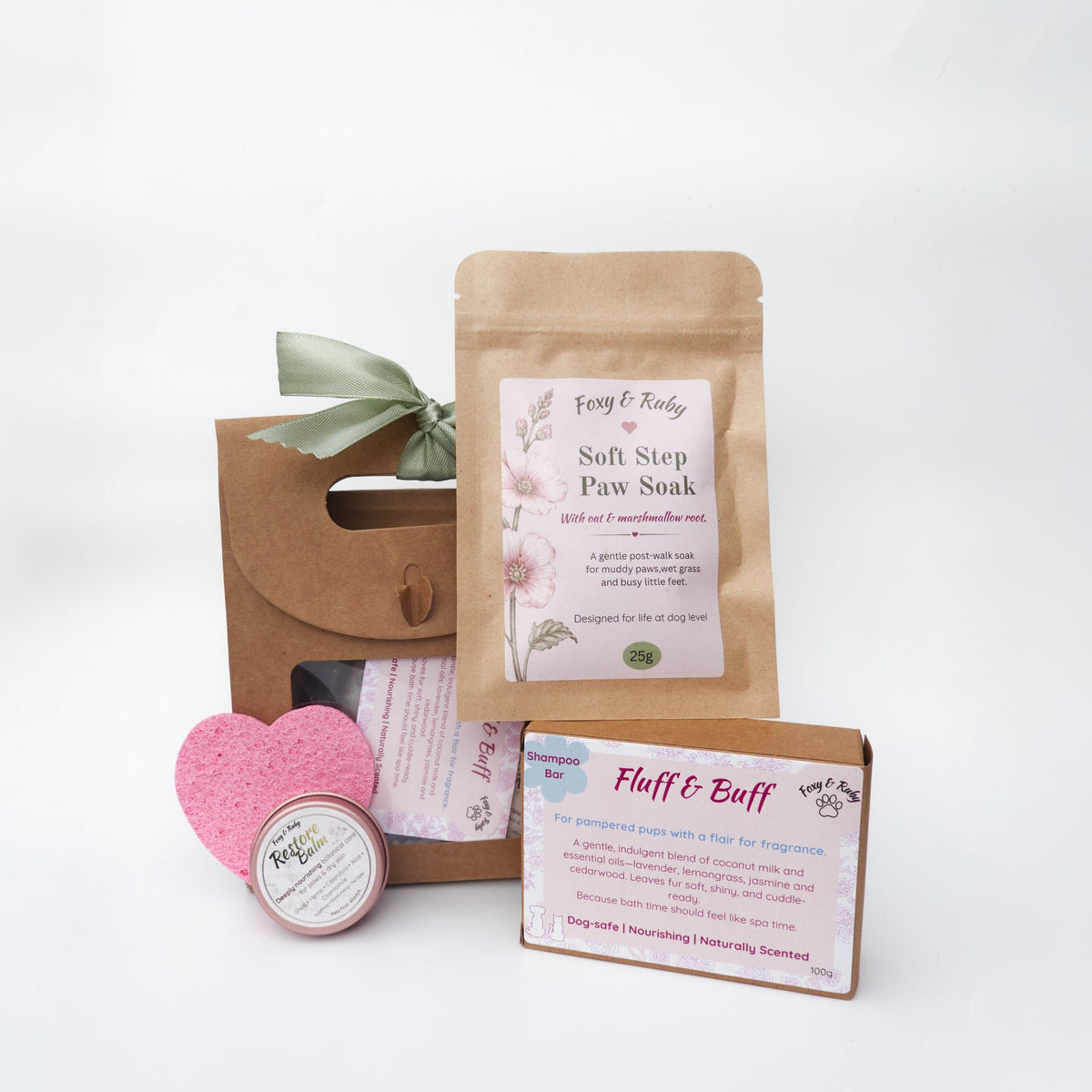 Foxy & Ruby Dog Spa Set arranged with its kraft gift bag and four coat and paw-care items