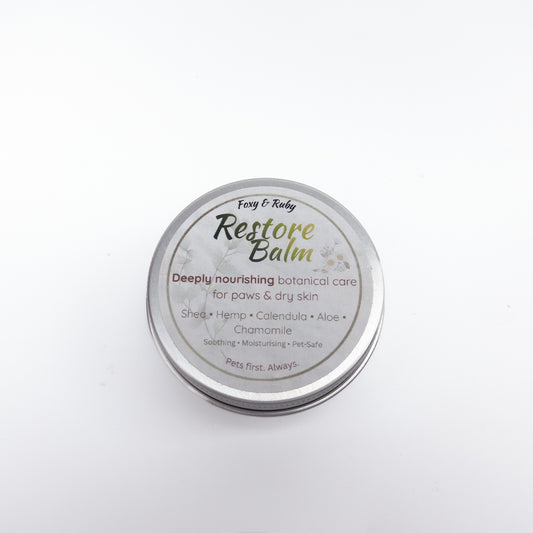Foxy & Ruby Restore Balm shown open beside the labelled tin